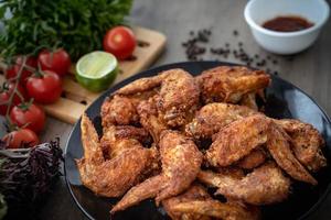 Hot Meat Dishes - Fried Chicken Wings on plate with salad photo