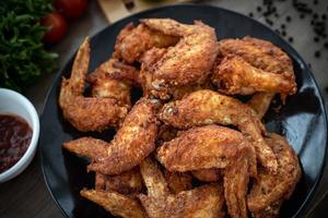 Hot Meat Dishes - Fried Chicken Wings on plate with salad photo