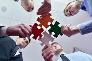 Group of business people assembling jigsaw puzzle photo