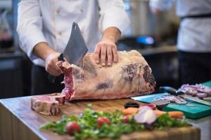 chef cutting big piece of beef photo