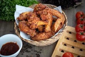 Breaded crispy fried kentucky chicken drumctick in the basket photo