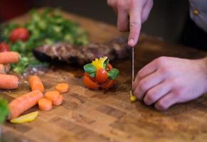 closeup of Chef hands preparing beef steak photo