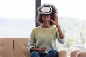 black woman using VR headset glasses of virtual reality photo