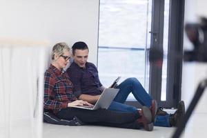 startup business, couple working on laptop computer at office photo