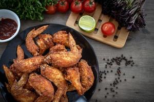 Hot Meat Dishes - Fried Chicken Wings on plate with salad photo