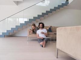 couple relaxing at  home with tablet computers photo