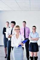 business woman standing with her staff in background photo