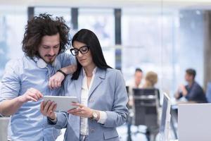 Business People Working With Tablet in startup office photo