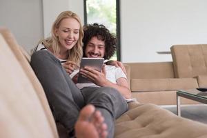 couple relaxing at  home with tablet computers photo