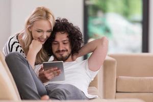 couple relaxing at  home with tablet computers photo