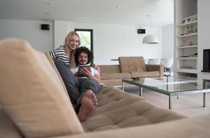 couple relaxing at  home with tablet computers photo