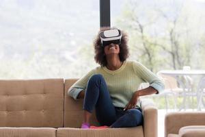 black woman using VR headset glasses of virtual reality photo