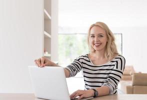 Young woman with laptop at home photo