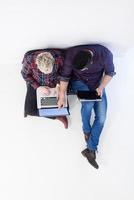 top view of  couple working on laptop computer at startup office photo