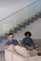 multiethnic couple relaxing at  home with tablet computers photo