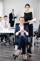 business woman with her staff in background photo