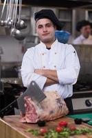 chef cutting big piece of beef photo