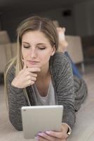 young women used tablet computer on the floor photo