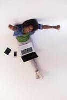 african american woman sitting on floor with laptop top view photo