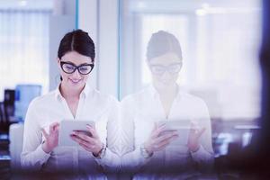 Business Woman Using Digital Tablet in front of startup Office photo