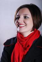 Portrait of a young woman wearing red scarf photo