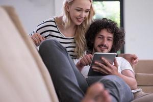 couple relaxing at  home with tablet computers photo