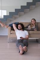 young couple relaxes in the living room photo