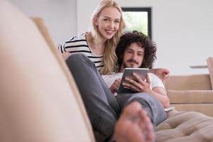 couple relaxing at  home with tablet computers photo