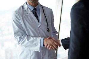 doctor handshake with a patient photo