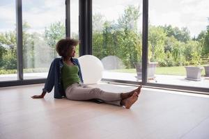 african american  woman  sitting near window photo