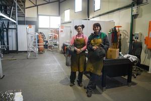 portrait of two welders holding welding masks in their hands and preparing for hard work in a factory photo