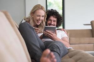 couple relaxing at  home with tablet computers photo