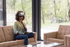 black woman using VR headset glasses of virtual reality photo