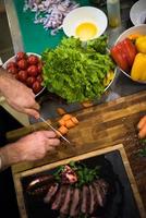 top view of Chef hands serving beef steak photo