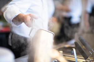 chef preparing food, frying in deep fryer photo