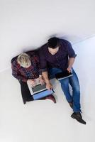 top view of  couple working on laptop computer at startup office photo