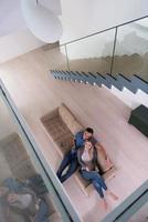 youg couple in living room with tablet top view photo