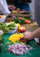 Chef hands cutting fresh and delicious vegetables photo