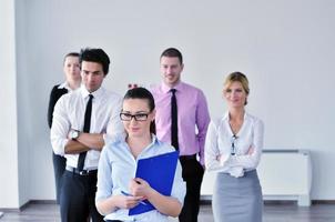 business woman standing with her staff in background photo