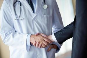 doctor handshake with a patient photo