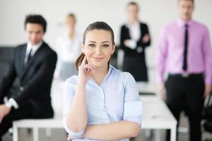 business woman standing with her staff in background photo