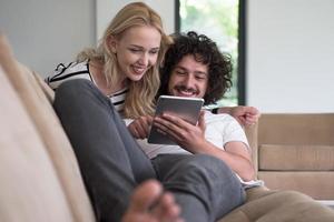 couple relaxing at  home with tablet computers photo