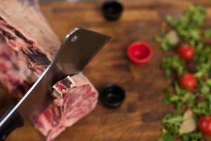 chef cutting big piece of beef photo