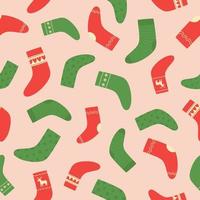 Seamless pattern of red and green Christmas socks on pink background. Doodle style. Christmas winter background. vector