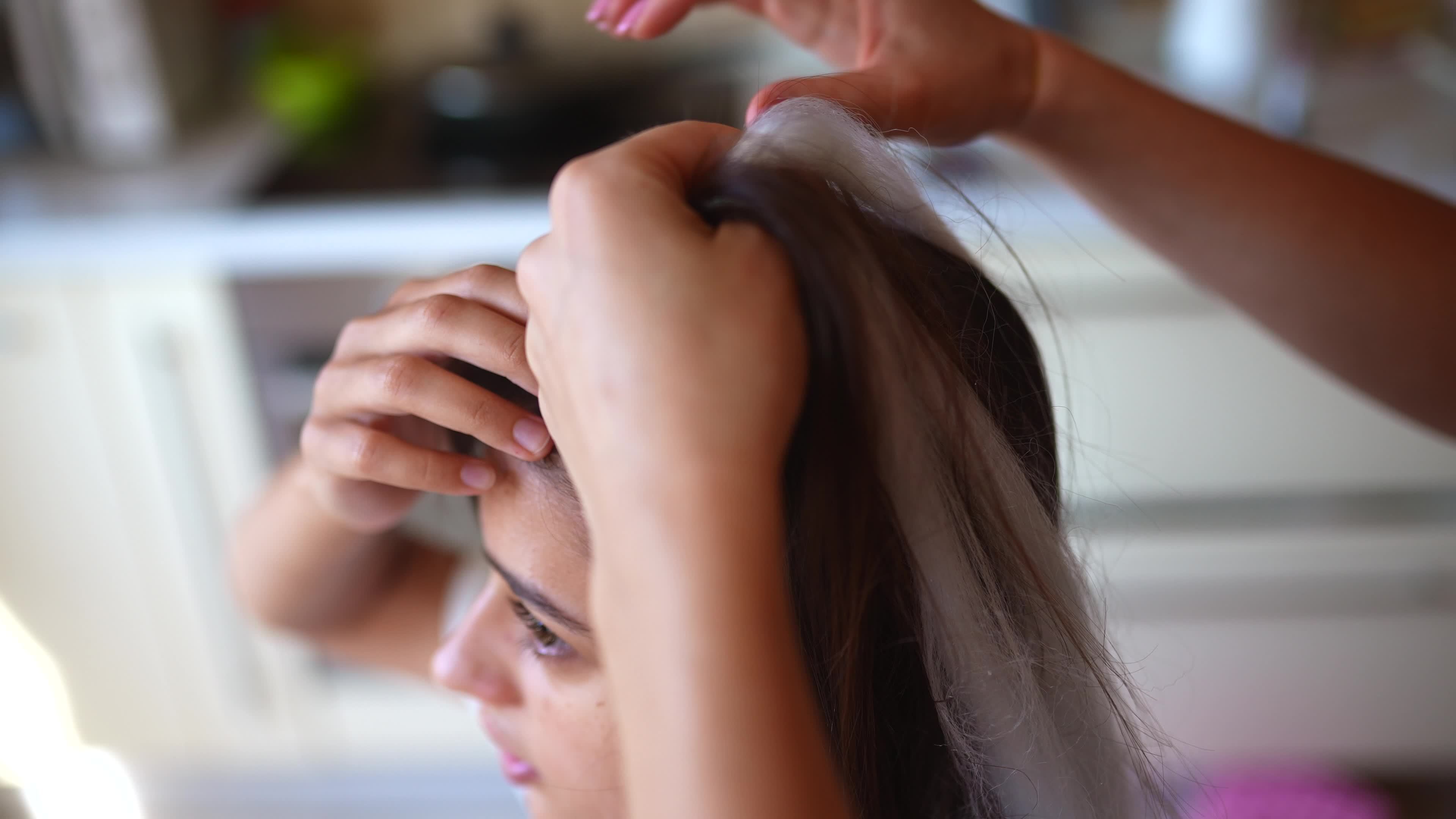 Girls braiding hair with a white strand of hair 12143915 Stock Video at