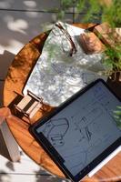 furniture design, digital drawing in tablet and analog in notebook photo