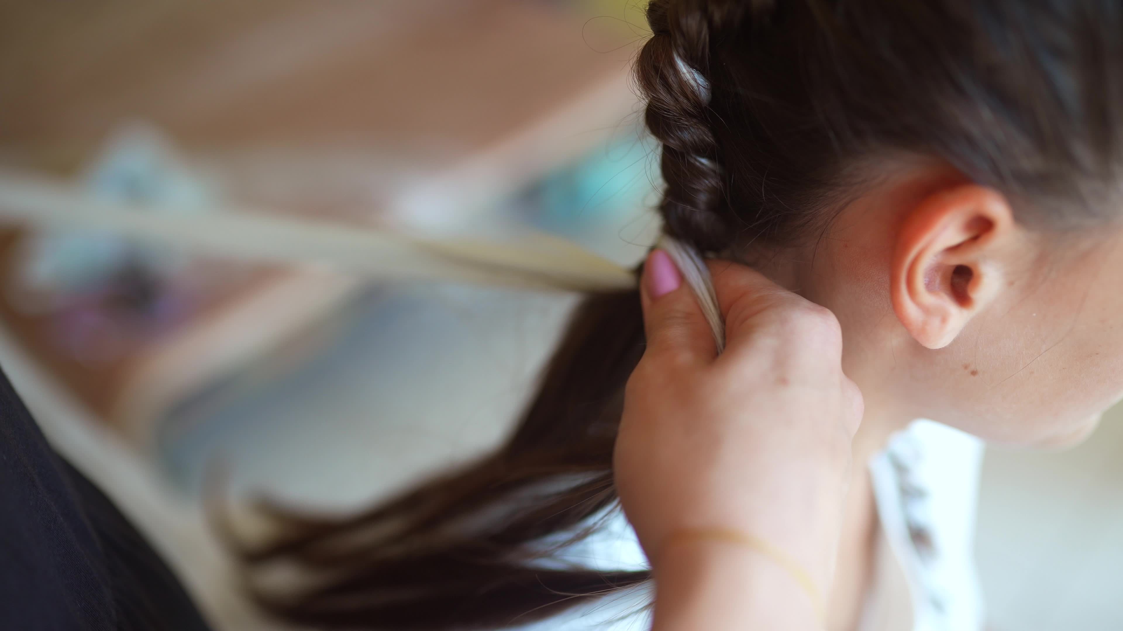 Girls braiding hair with a white strand of hair 12149859 Stock Video at