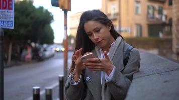 mujer ocupada en la calle con smartphone video