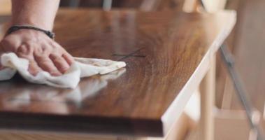 Master carpenter Applying furniture oil to the table Table top solid walnut. Part 1 video