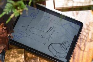 furniture design, digital drawing in tablet and analog in notebook photo